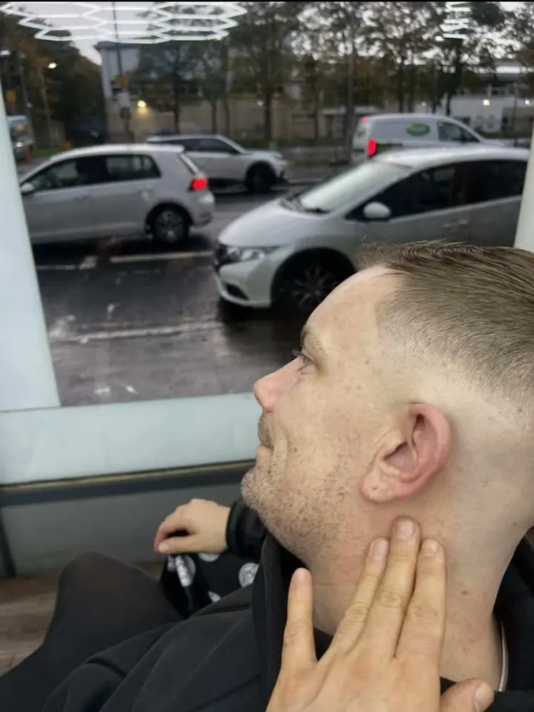 Customer getting a fade by the shop window